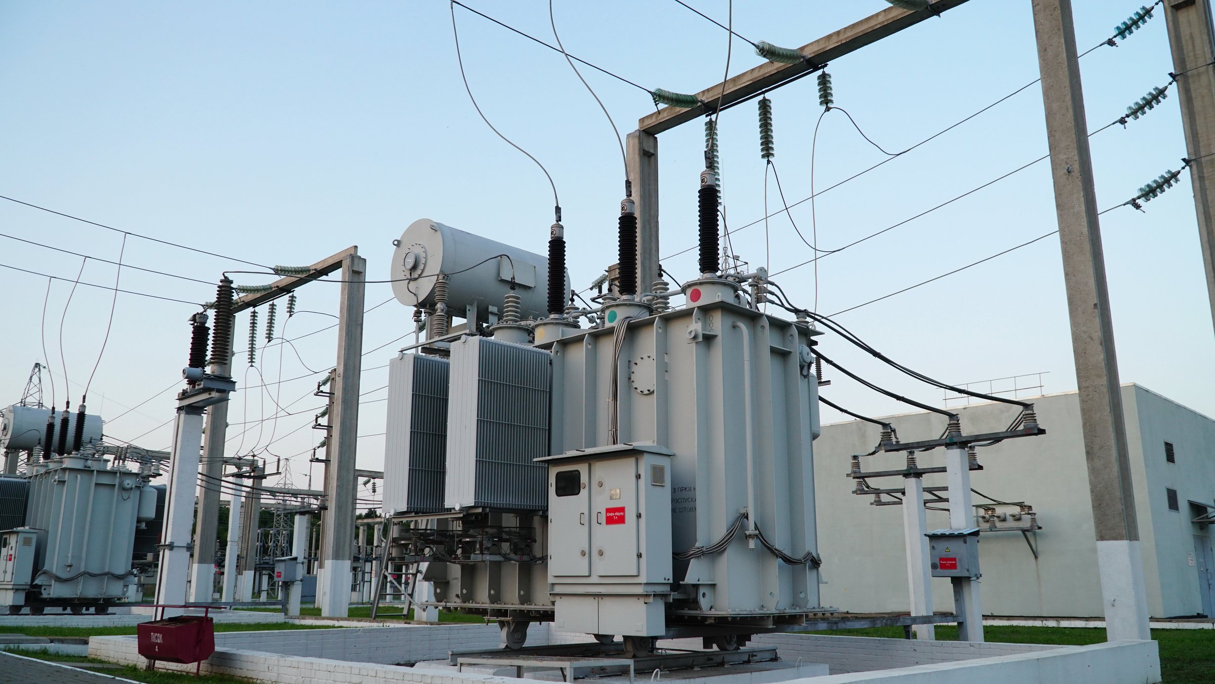 Power transformer. Electrical equipment. Electric substation. High voltage transformer against the blue sky. Electric current redistribution substation